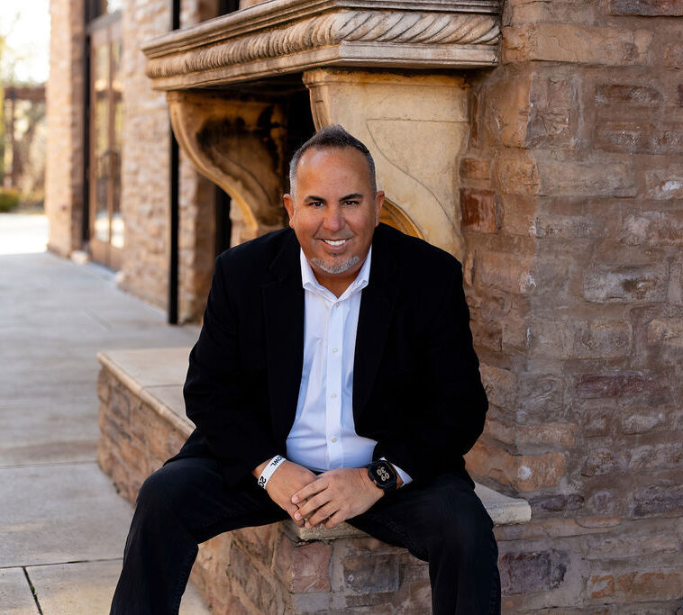 Soto-Sitting-Front-of-Fireplace-LOW-REZ-e1772830429551 mark coach soto realtor